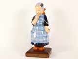 a figurine of a woman wearing a blue and white dress