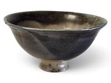 a black bowl sitting on top of a white table