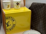 two bowls and two cups sitting on a table next to a bag