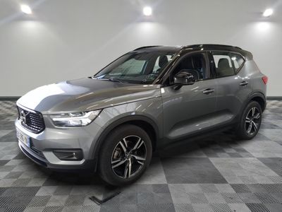 a silver volvo suv parked on a checkered floor in a garage