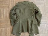 a green jacket on the floor on the floor