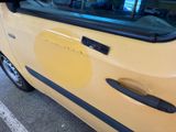 a yellow car with a sticker on the side of it