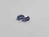 a pair of blue sapphires on a white surface
