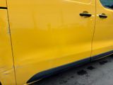 a yellow van that is parked on the side of the road