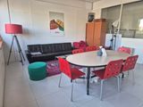a table and chairs in a living room with a couch