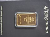 a close up of a gold bar on a card on a table
