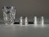 three silver cups sitting next to each other on top of a table