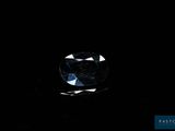 a close up of a blue diamond on a black background