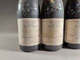 three bottles of wine sitting on top of a table next to each other