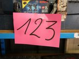 a pink sign that says 123 on it in front of a pile of tools