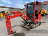 an image of a small red excavator parked in a lot