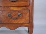 a small wooden chest of drawers with a clock on top