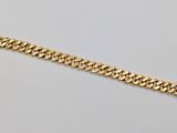 a gold chain bracelet on a white background