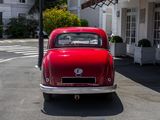 a red car that is parked in front of a building