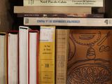 many books that are on a shelf in a box