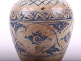 a blue and white vase sitting on a table