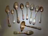a lot of silver spoons and forks arranged in a circle