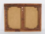 an old wooden frame with two doors and a cork board