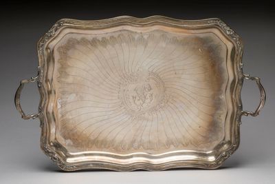 a silver tray with handles and handles on a gray surface