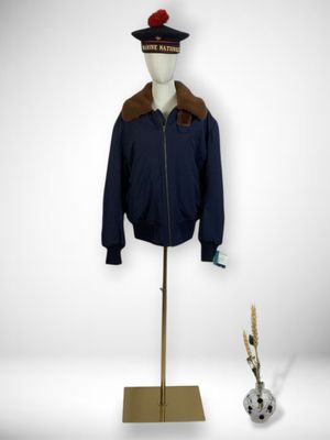 a mannequin with a hat and jacket on a stand