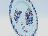 a blue and white plate with a blue and orange design on it
