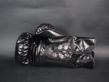 a pair of black boxing gloves on a black background