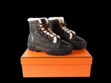a pair of black boots sitting on top of an orange box