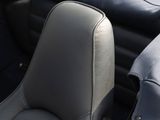 the interior of a sports car with black leather seats and a blue cover