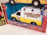 two toy ambulances are in a display box with the box open
