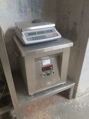 a scale sitting on top of a shelf next to a chair