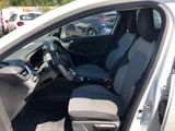 the interior of a car with the door open and the driver ' s seat down
