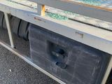 a truck that has a broken glass window on the back of it