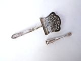 a close up of a spoon and a knife on a white surface