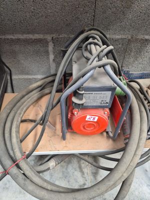 a red and black hose attached to a red and black machine