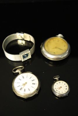three different types of pocket watches on a table with a black background
