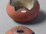two pieces of pottery that are sitting on a table