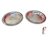 pair of silver plated bowls with red rims on a white background