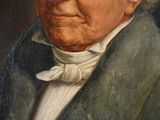 portrait of an old man with a white beard and a green jacket