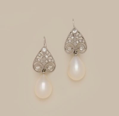 a pair of pearl and diamond earrings