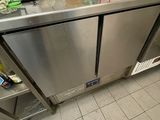 a stainless steel counter with a bunch of items on top of it