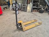 a fork lifter sitting in a garage with other tools