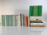many books stacked on top of each other on a table