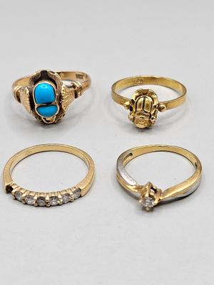 a group of five gold rings and a turquoise stone ring