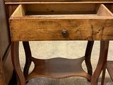 a small wooden table with a drawer on top of it