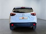 the back of a white car in a white room with a black floor