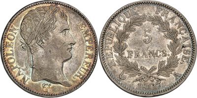 a silver coin with a woman ' s head and laurels on it