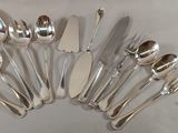 a lot of silver spoons and forks on the table