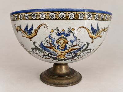 a blue and white bowl sitting on a stand
