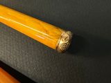 two different types of baseball bats on a table