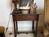 a small table with a lamp on top of it in a room